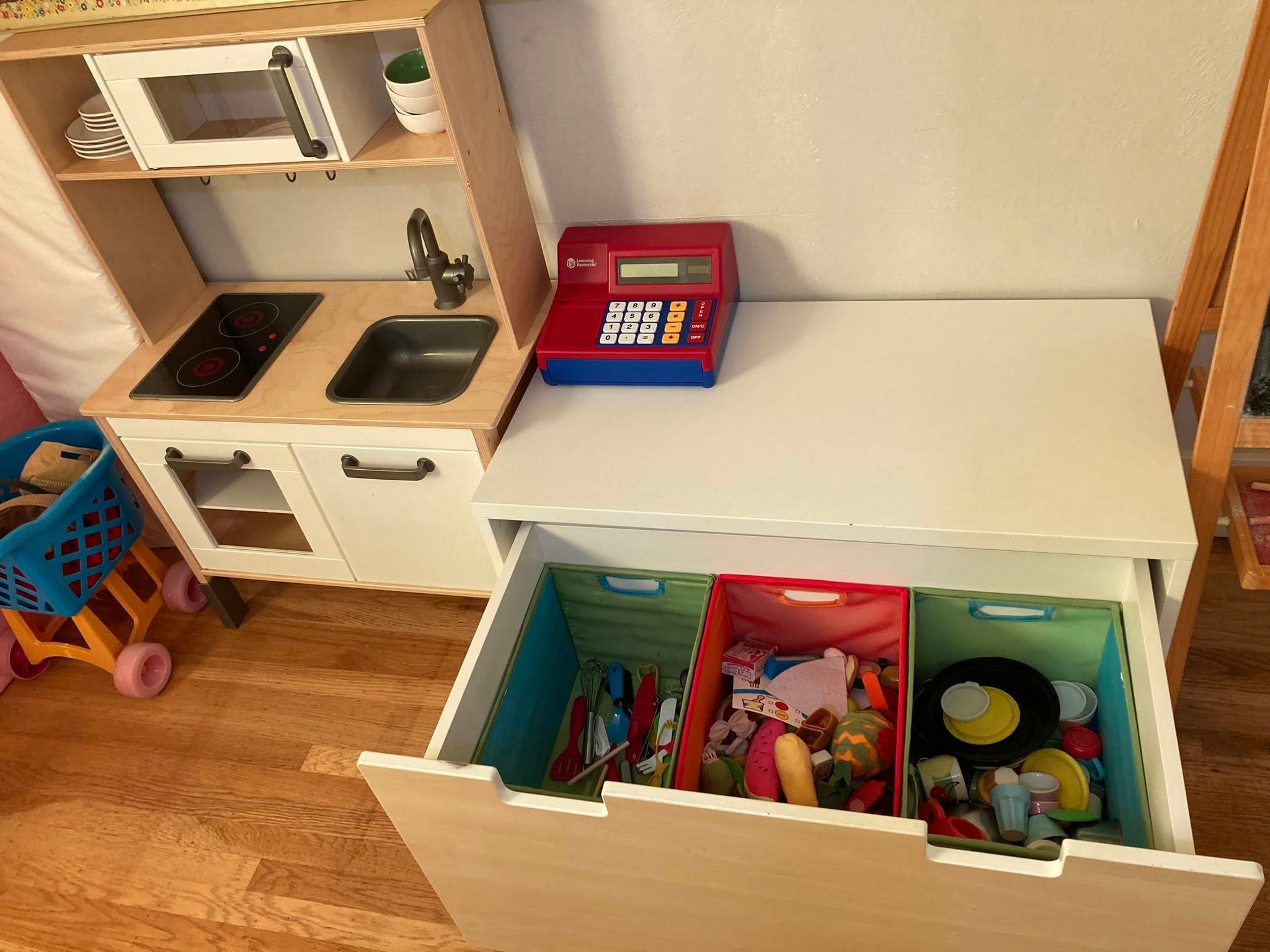 Kids play kitchen with organized storage drawers by Kiera Rain, professional organizer serving San Ramon CA
